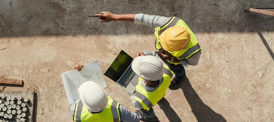 Contractor team during building inspection and construction plan analysis