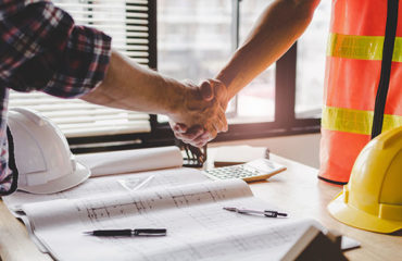 construction worker team hands shaking after consultation meeting