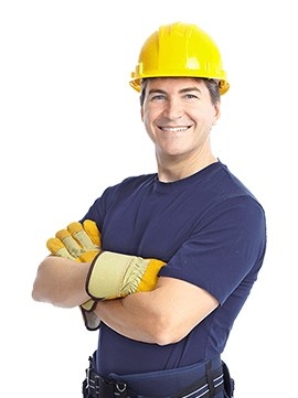 A smiling construction man with his arms crossed