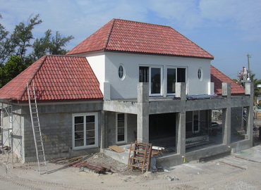 A white and pink home that is under construction