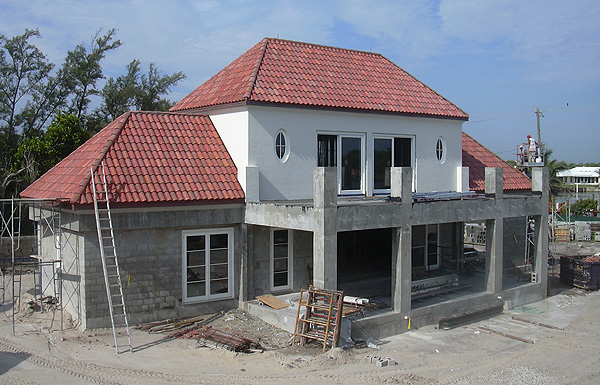 A white and pink home that is under construction