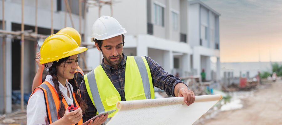 Builder discussing property map with his team mate